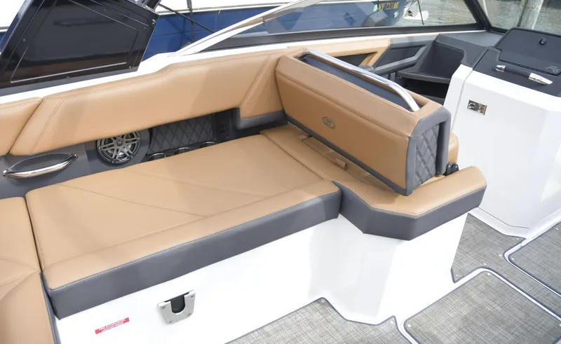 Slide: The Image of 2022 Cobalt R6 boat interior with tan and gray seating, modern design, and spacious layout. - 15