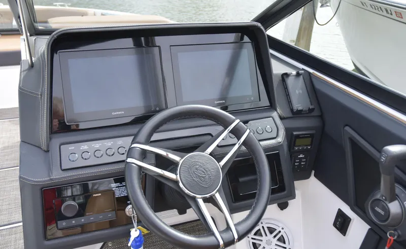 Slide: The Image of 2022 Cobalt R6 boat dashboard with dual Garmin displays and steering wheel. - 17