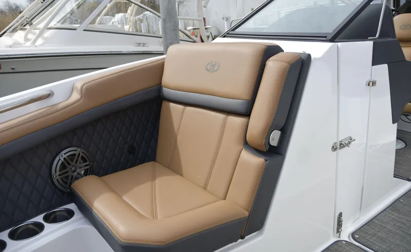 Slide: The Image of 2022 Cobalt R6 boat interior with tan leather seating and speaker detail. - 24