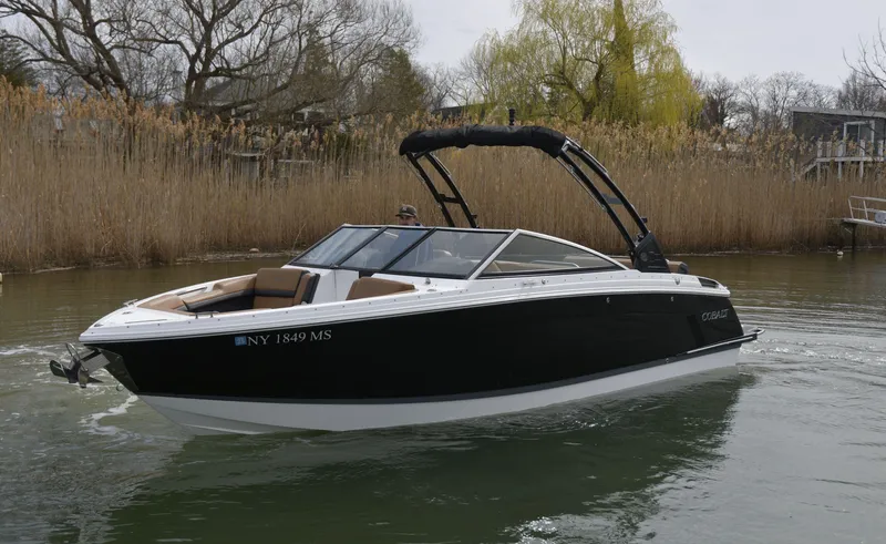 Slide: The Image of 2022 Cobalt R6 boat cruising on a calm river with reeds in the background. - 3