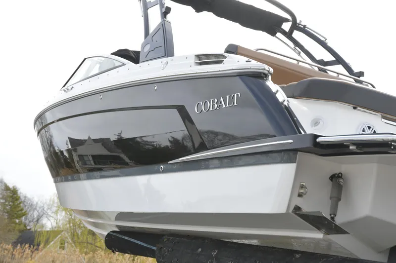 Slide: The Image of 2022 Cobalt R6 boat with sleek design, docked outdoors. - 31