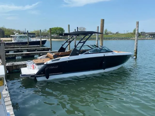 Slide: The Image of 2022 Cobalt R6 boat docked in a marina on a sunny day. - 36