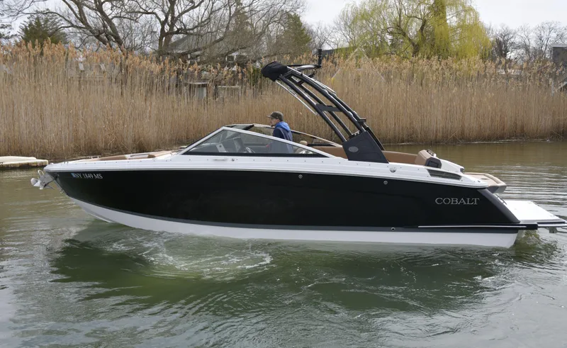 Slide: The Image of 2022 Cobalt R6 boat cruising on a calm river with reeds in the background. - 6