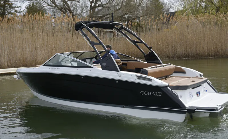 Slide: The Image of 2022 Cobalt R6 boat cruising on a calm waterway, surrounded by reeds. - 7