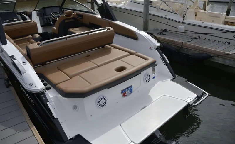 Slide: The Image of 2022 Cobalt R6 boat with tan seating, docked at a marina. - 9