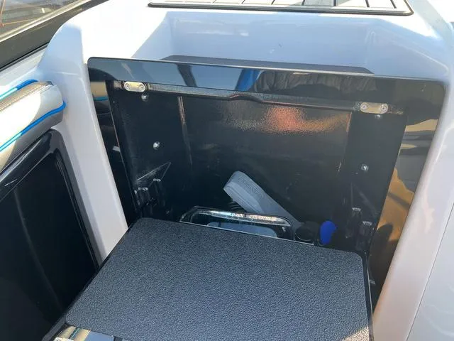 Slide: The Image of 2020 Yamaha AR240 boat storage compartment with open hatch, showcasing interior space. - 11