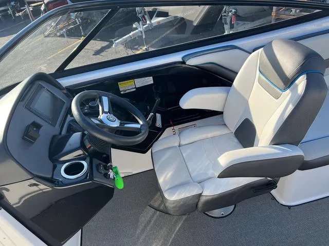 Slide: The Image of 2020 Yamaha Boats AR240 cockpit with steering wheel and captain's chair. - 13