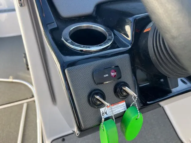 Slide: The Image of Control panel of a 2020 Yamaha AR240 boat with cup holder and ignition keys. - 17