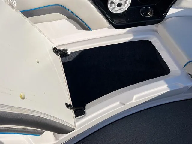 Slide: The Image of 2020 Yamaha AR240 boat storage compartment with open hatch, featuring sleek interior design. - 20