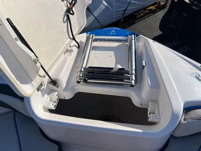 Slide: The Image of 2020 Yamaha AR240 boat ladder compartment with open hatch, showcasing storage space. - 22