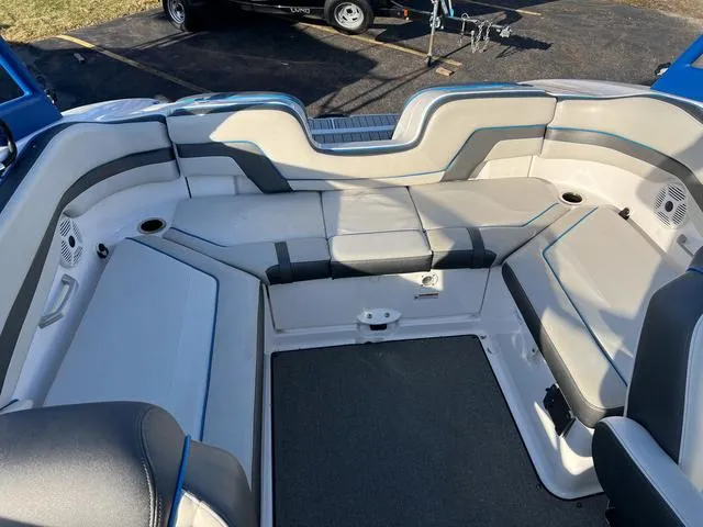 Slide: The Image of 2020 Yamaha Boats AR240 interior seating area with gray and blue upholstery. - 7