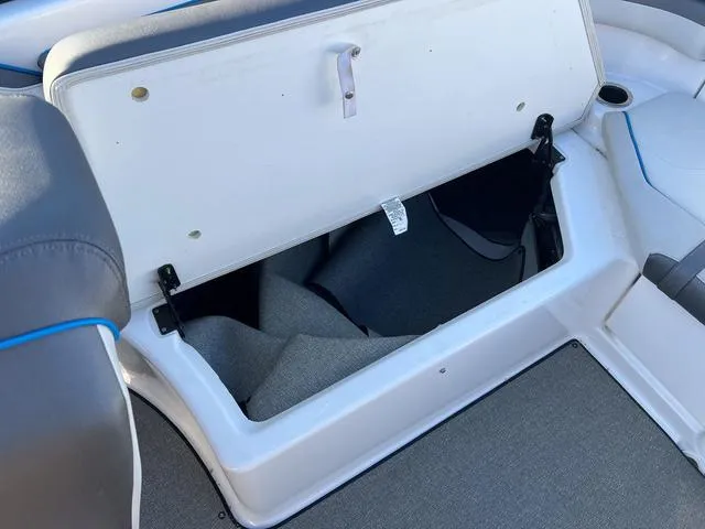 Slide: The Image of 2020 Yamaha AR240 boat storage compartment with open lid, showcasing interior space. - 9