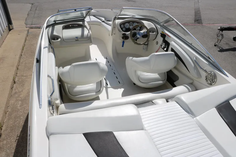 Slide: The Image of 2009 Glastron GT185 boat interior with white seating and steering console. - 12