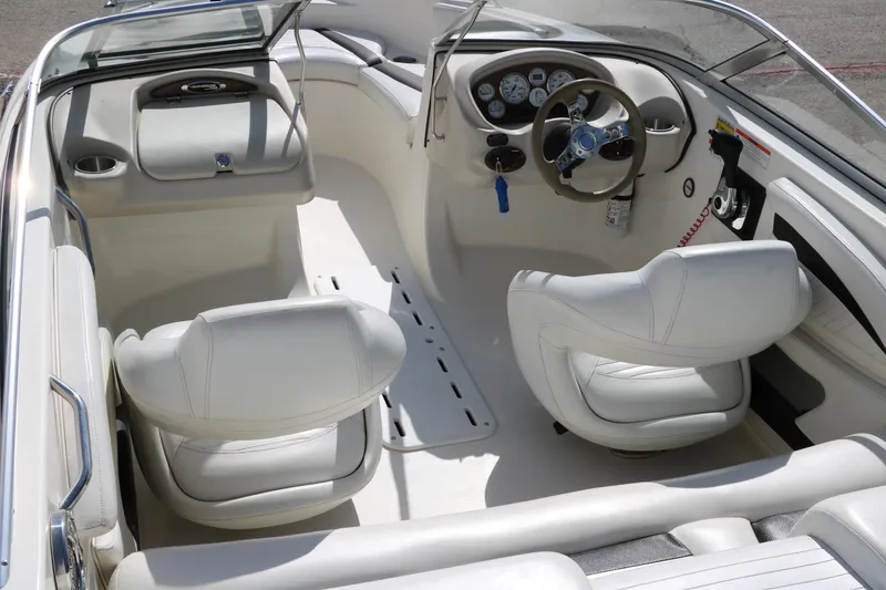 Slide: The Image of 2009 Glastron GT185 boat interior with white seating and modern dashboard controls. - 13
