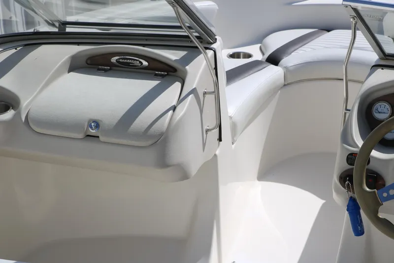 Slide: The Image of 2009 Glastron GT185 boat interior with steering wheel and seating area. - 16