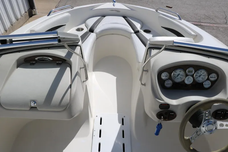 Slide: The Image of 2009 Glastron GT185 boat interior with dashboard and seating. - 17