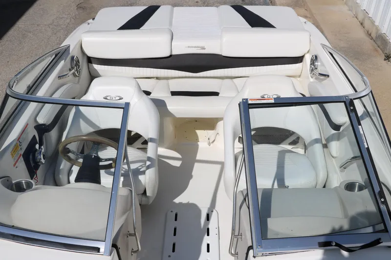 Slide: The Image of 2009 Glastron GT185 boat interior with white seating and dual windshields. - 18