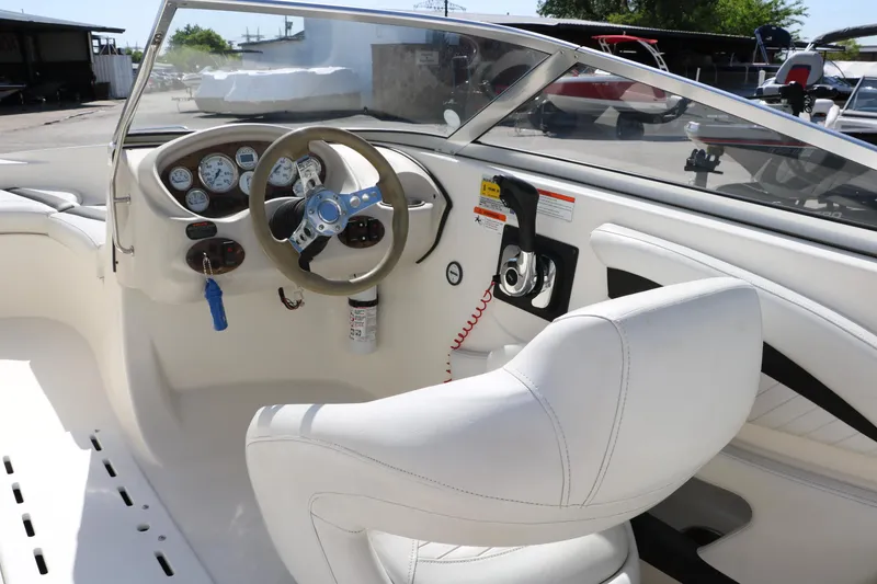 Slide: The Image of 2009 Glastron GT185 boat interior with steering wheel and dashboard controls. - 22