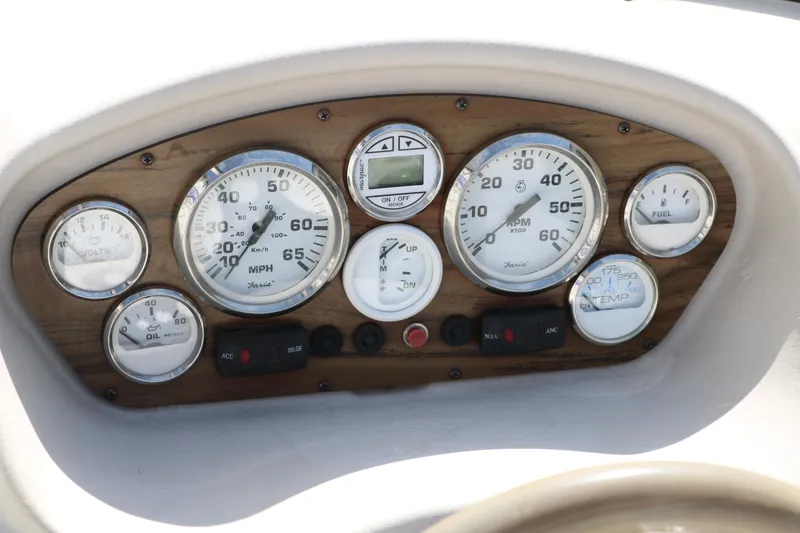 Slide: The Image of Dashboard of a 2009 Glastron GT185 boat with various gauges and controls. - 26