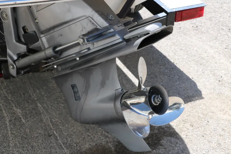 Slide: The Image of 2009 Glastron GT185 boat propeller and outdrive on concrete surface. - 30