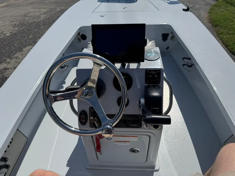 Slide: The Image of 2023 Hell's Bay Professional boat console with steering wheel and navigation equipment. - 10