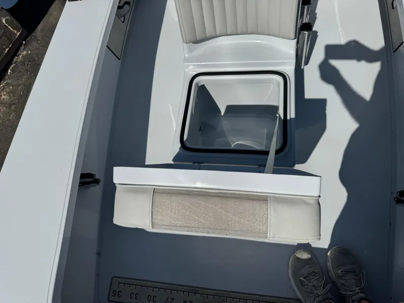 Slide: The Image of 2023 Hell's Bay Professional boat interior with seating and storage compartment. - 16