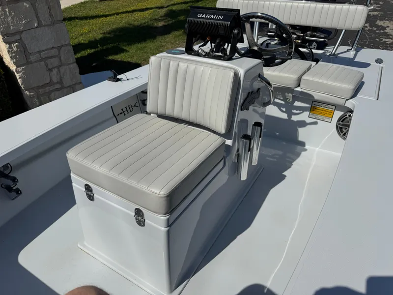 Slide: The Image of 2023 Hell's Bay Professional boat interior with Garmin system and cushioned seating. - 17