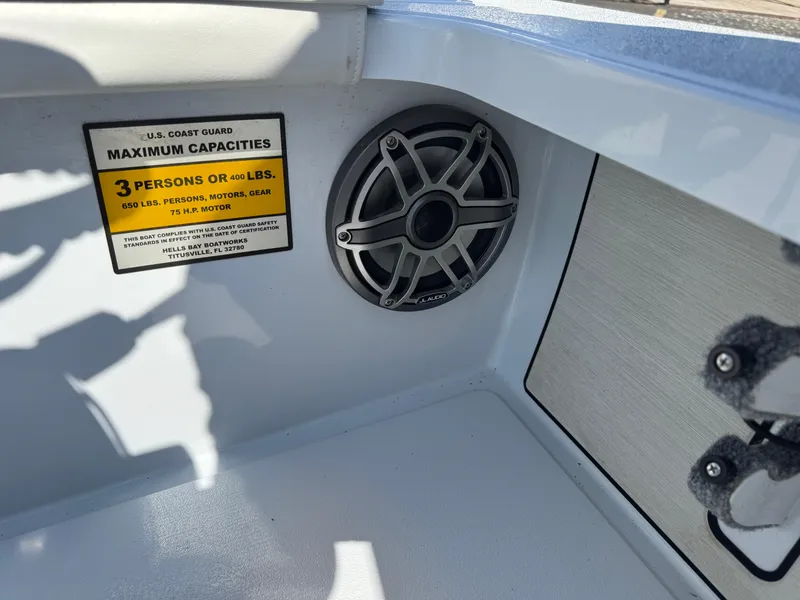 Slide: The Image of 2023 Hell's Bay Professional boat interior with capacity label and speaker. - 18