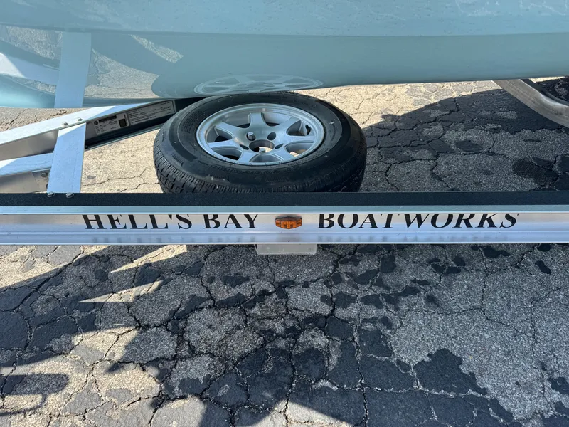 Slide: The Image of 2023 Hell's Bay Professional boat trailer on cracked pavement. - 2