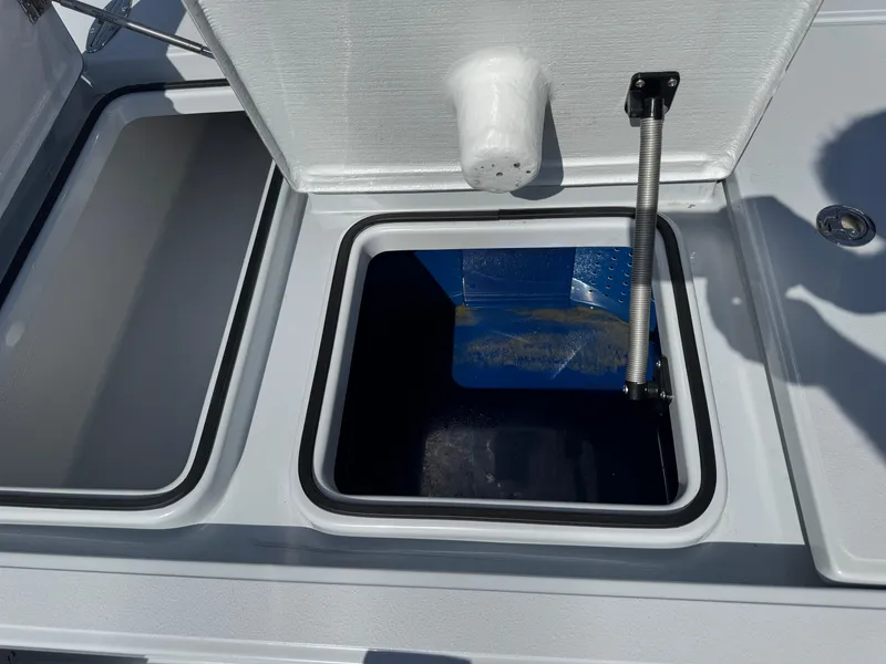 Slide: The Image of 2023 Hell's Bay Professional boat storage compartment with open lid and hydraulic support. - 21