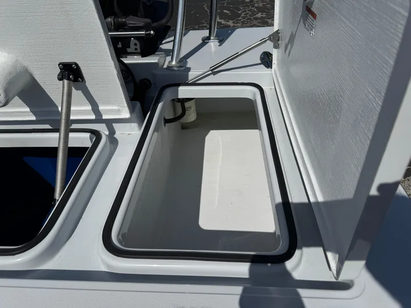 Slide: The Image of Open storage compartment on a 2023 Hell's Bay Professional boat. - 22