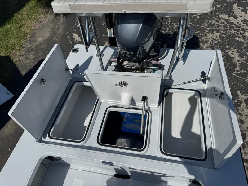 Slide: The Image of 2023 Hell's Bay Professional boat with open storage compartments and motor, viewed from above. - 24