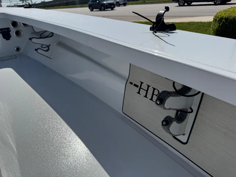 Slide: The Image of 2023 Hell's Bay Professional boat interior with rod holders and logo detail. - 28