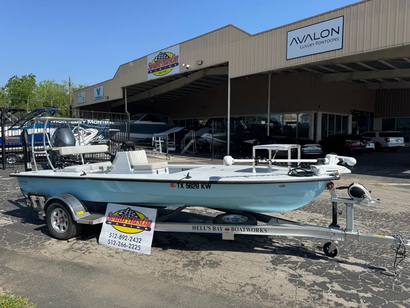 Slide: The Image of 2023 Hell's Bay Professional boat on trailer outside dealership, featuring sleek design and modern amenities. - 3