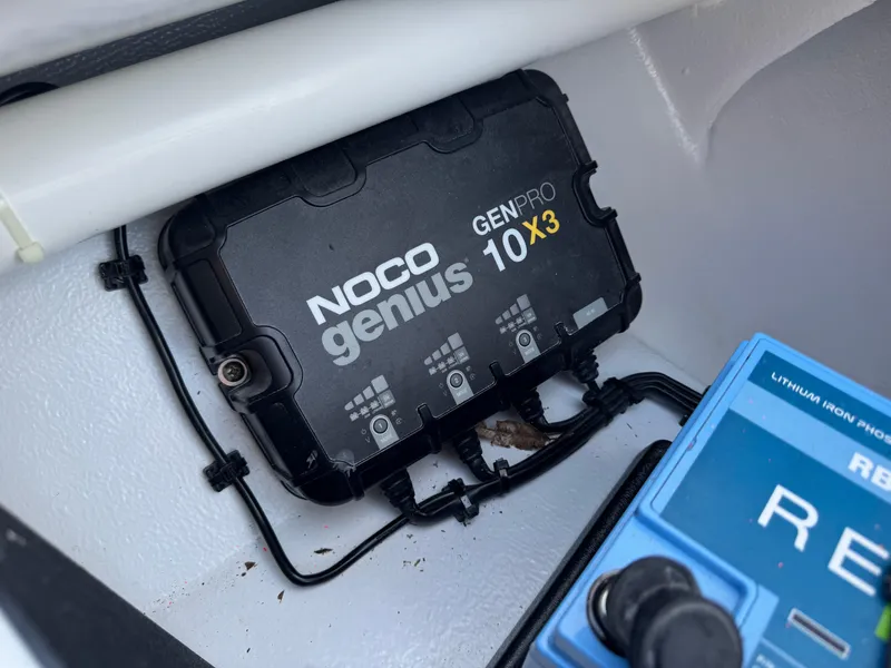 Slide: The Image of NOCO Genius GENPRO 10X3 charger in 2023 Hell's Bay Professional boat compartment. - 33