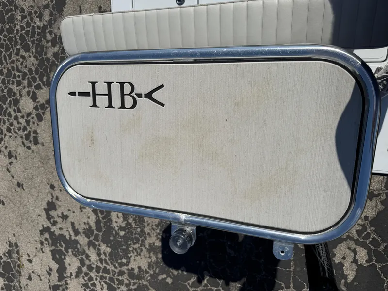 Slide: The Image of 2023 Hell's Bay Professional boat seat with HB logo on textured surface. - 38