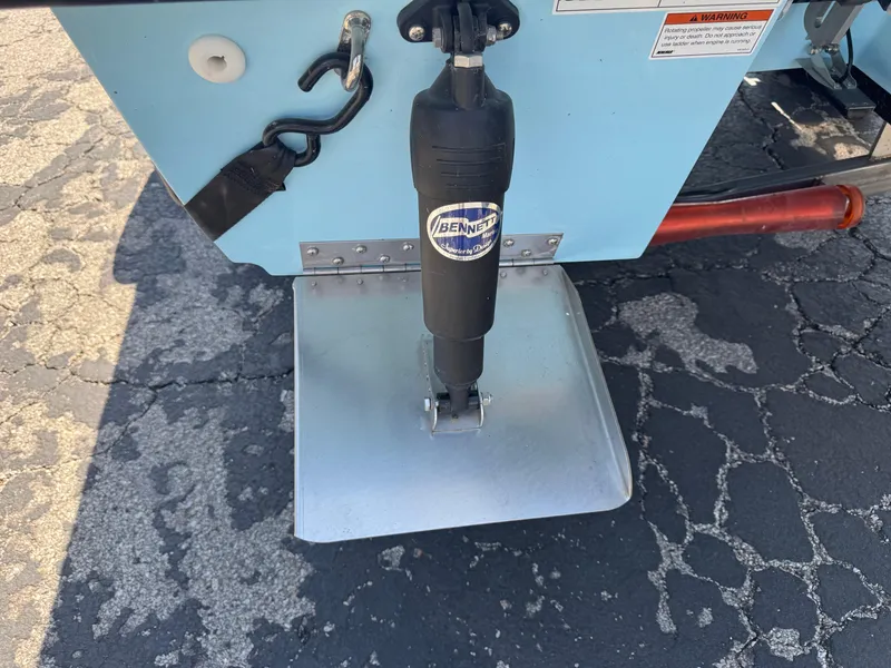 Slide: The Image of 2023 Hell's Bay Professional boat with Bennett trim tab on asphalt surface. - 5