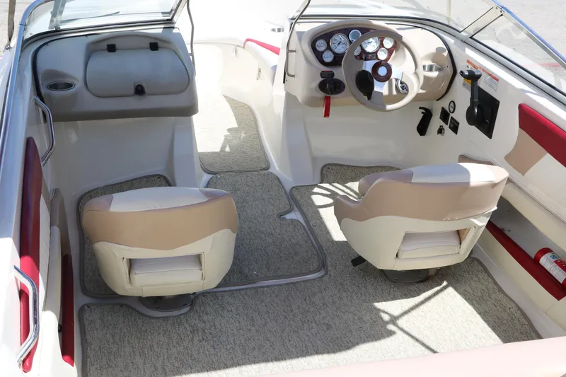 Slide: The Image of 2007 Glastron GT205 boat interior with beige seats and modern dashboard. - 14