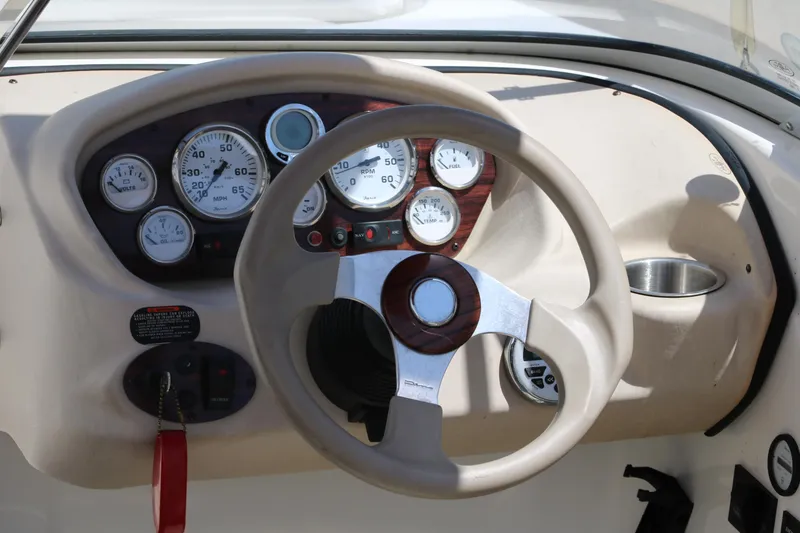 Slide: The Image of 2007 Glastron GT205 boat dashboard with steering wheel and gauges. - 15