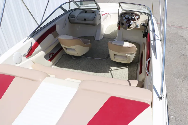 Slide: The Image of 2007 Glastron GT205 boat interior with beige and red seating, steering wheel, and dashboard. - 16