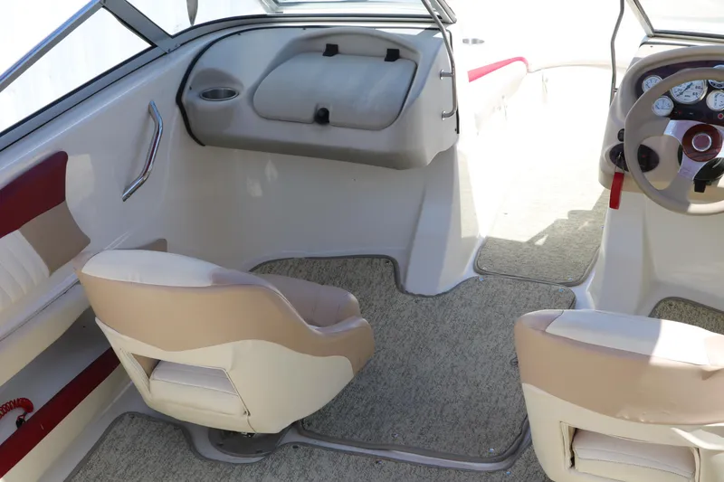Slide: The Image of Interior of a 2007 Glastron GT205 boat with beige seating and dashboard. - 17