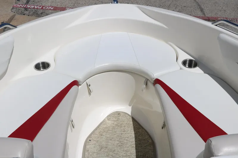 Slide: The Image of 2007 Glastron GT205 boat interior with red accents and cup holders. - 18