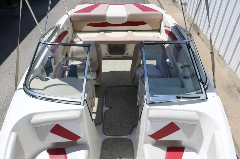 Slide: The Image of 2007 Glastron GT205 boat interior with red and white seating, open cockpit view. - 19