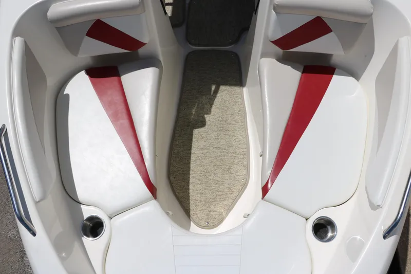 Slide: The Image of 2007 Glastron GT205 boat interior with red accents and cup holders. - 20