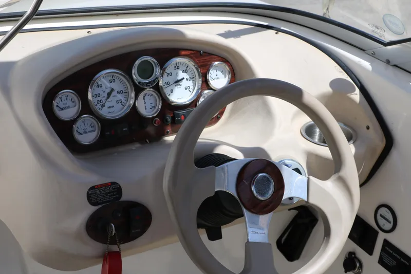 Slide: The Image of 2007 Glastron GT205 boat dashboard with steering wheel and gauges. - 22