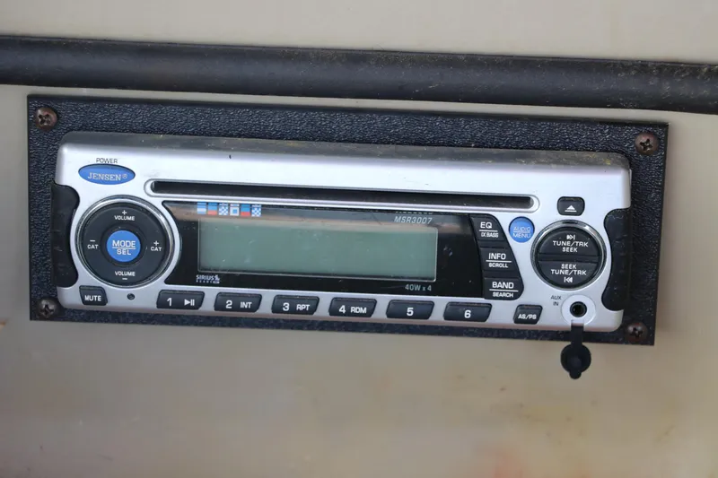 Slide: The Image of Jensen stereo system in a 2007 Glastron GT205 boat dashboard. - 23