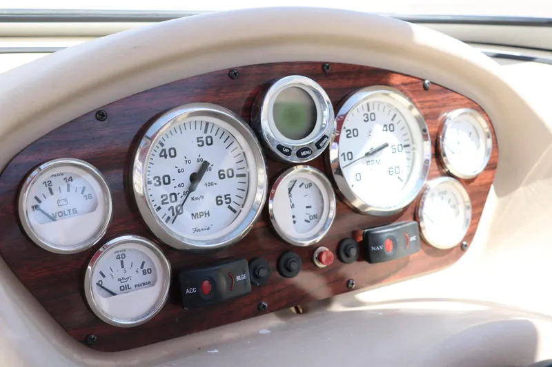 Slide: The Image of Dashboard of a 2007 Glastron GT205 boat with various gauges and controls. - 29