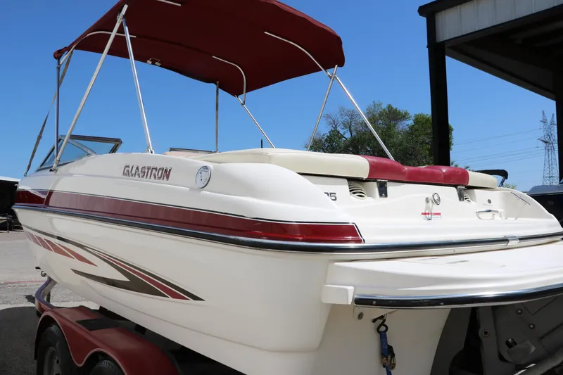 Slide: The Image of 2007 Glastron GT205 boat with red canopy and sleek design. - 7