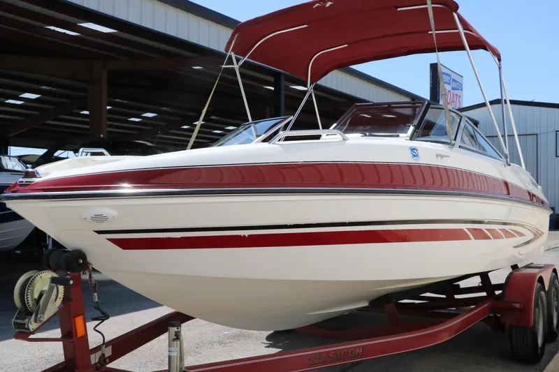 Slide: The Image of 2007 Glastron GT205 boat with red and white design on a trailer. - 8