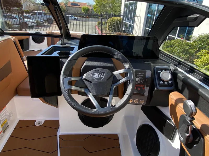 Slide: The Image of 2025 Malibu Wakesetter 22 MXZ boat interior with modern steering and dashboard controls. - 10